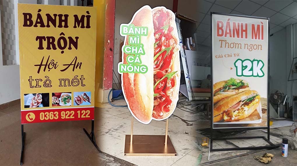 Biển hiệu bánh mì vẫy đứng màu đỏ cam, nổi bật với hình ảnh ổ bánh mì, thu hút sự chú ý từ xa