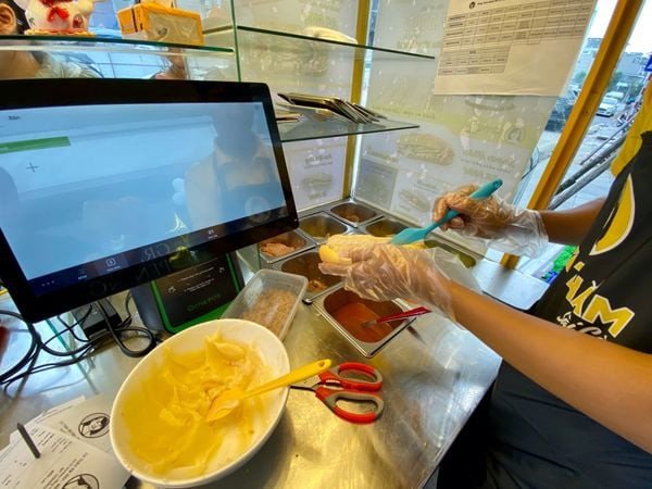 Chủ kiosk chụp ảnh cùng đội ngũ hỗ trợ bánh mì cô hạ
