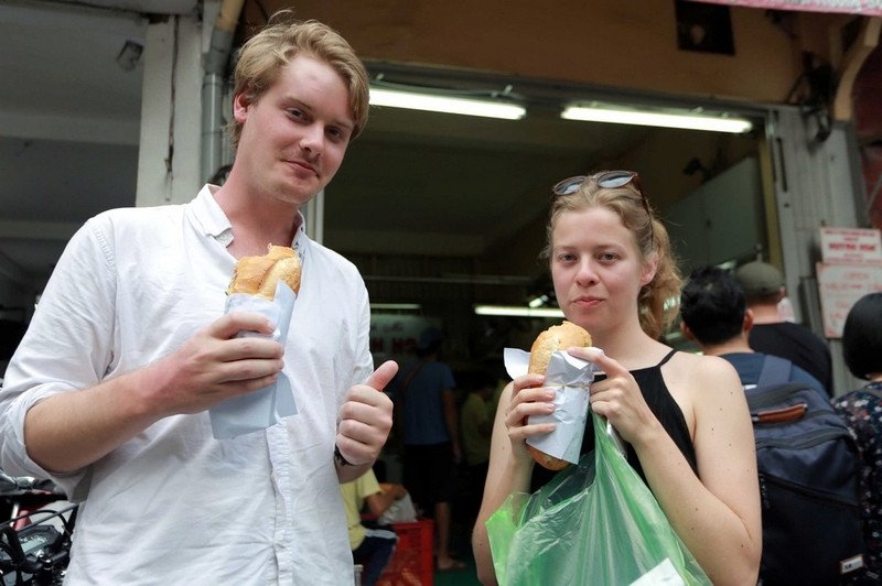 Du khách vui vẻ thưởng thức bánh mì