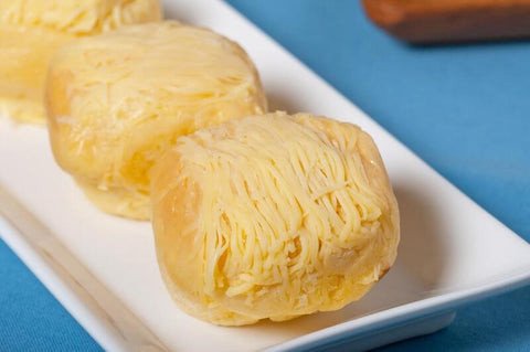 Ensaymada Philippines ngọt ngào phủ đầy phô mai bào và đường