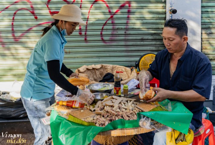 Giò chả phong phú trên mẹt lá chuối tại quầy bánh mì Cụ Lý