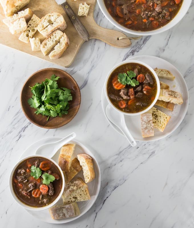 Hai đĩa bò sốt vang và bánh mì cắt lát, bữa ăn chuẩn vị cho bánh mì sốt vang.