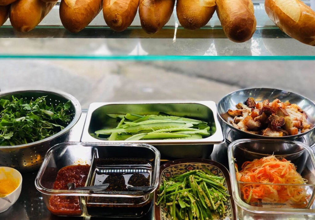 Món bánh mì kẹp thịt nguội và rau thơm tươi ngon