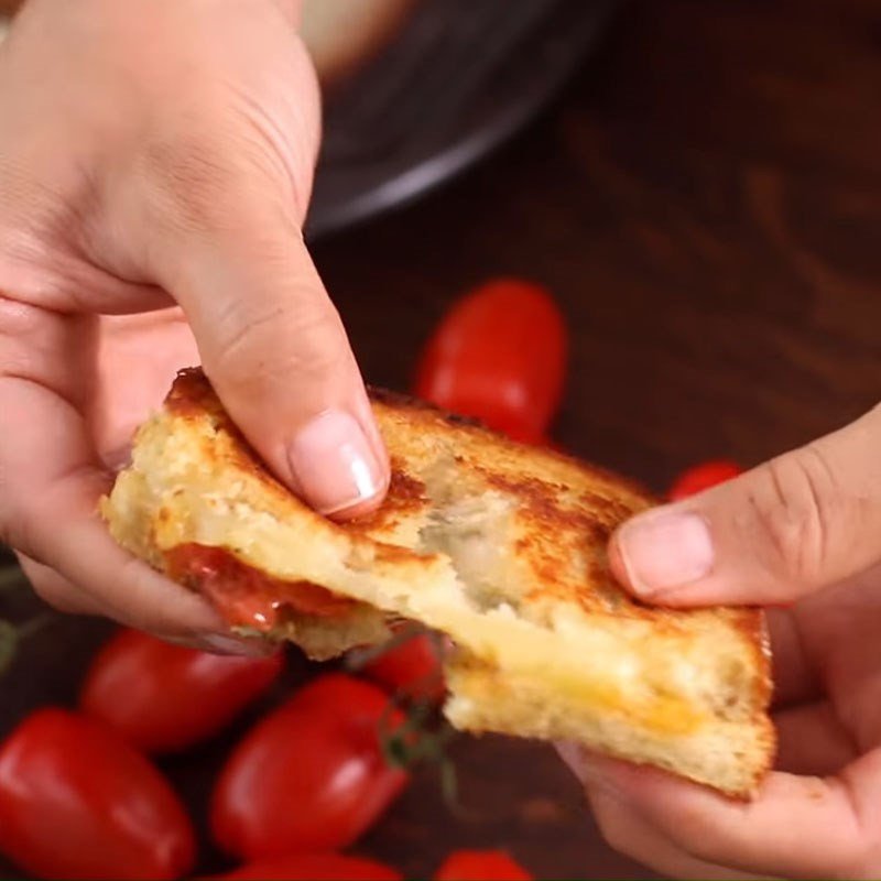 Món bánh mì sandwich kẹp phô mai cà chua nướng đã hoàn thành và cắt lát