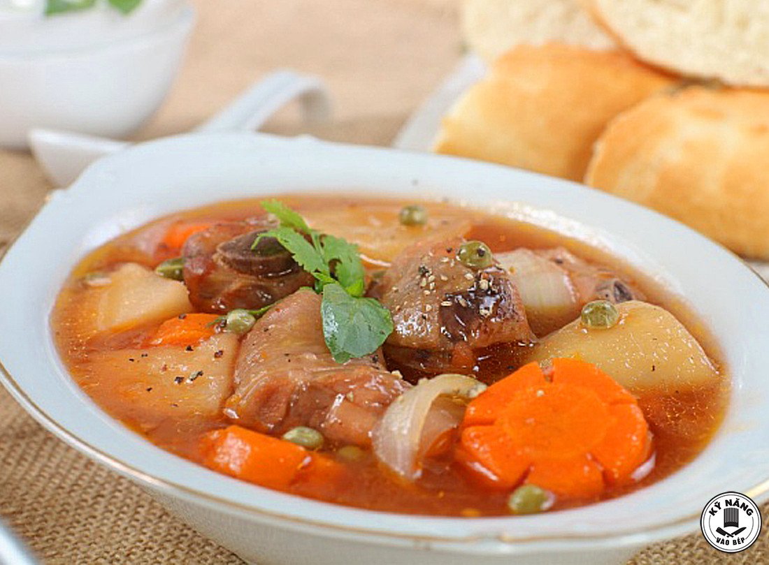 Món gà lagu ăn với bánh mì nóng hổi, trang trí rau mùi hấp dẫn