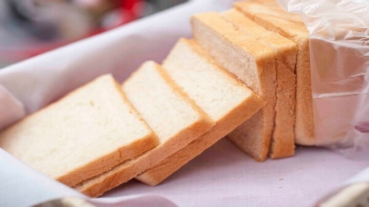 Một lát bánh mì sandwich tươi ngon trên thớt gỗ, minh họa thời hạn sử dụng bánh mì.