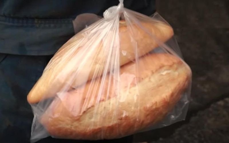 Người dân địa phương và du khách đang mua bánh mì mỏ Quảng Ninh tại một khu chợ truyền thống