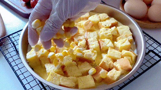 Rải đều ngô ngọt và lạp xưởng thái lát lên trên đế bánh pizza từ bánh mì cũ