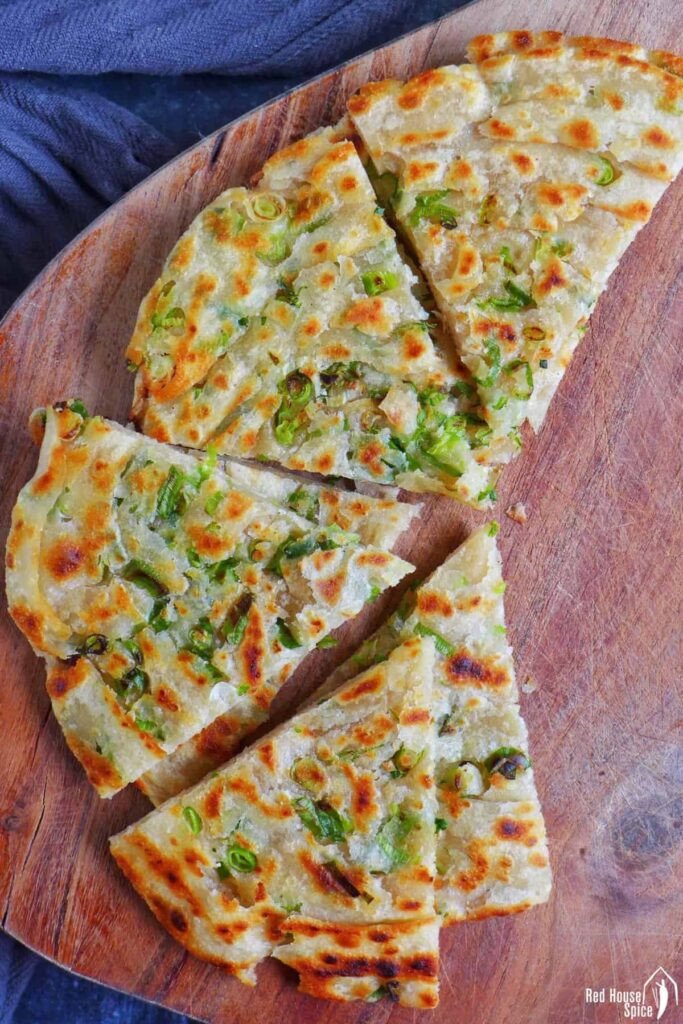 Bánh hành chiên Trung Quốc vàng ruộm được cắt thành từng miếng tam giác, sẵn sàng để thưởng thức.