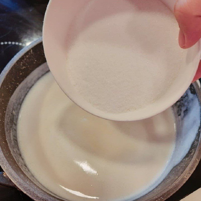 Đun sữa đậu xanh trên bếp, khuấy đều