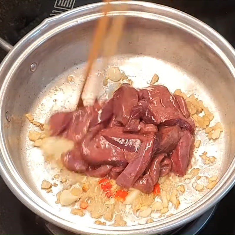Gan lợn đang được xào đều trên chảo nóng