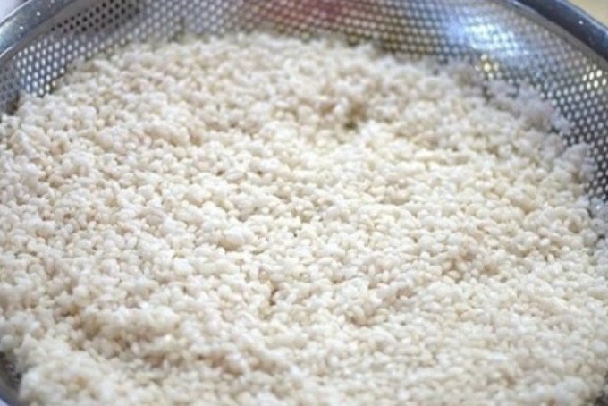 Gạo nếp sau khi ngâm được vớt ra rổ để ráo nước hoàn toàn, sẵn sàng cho công đoạn hấp xôi