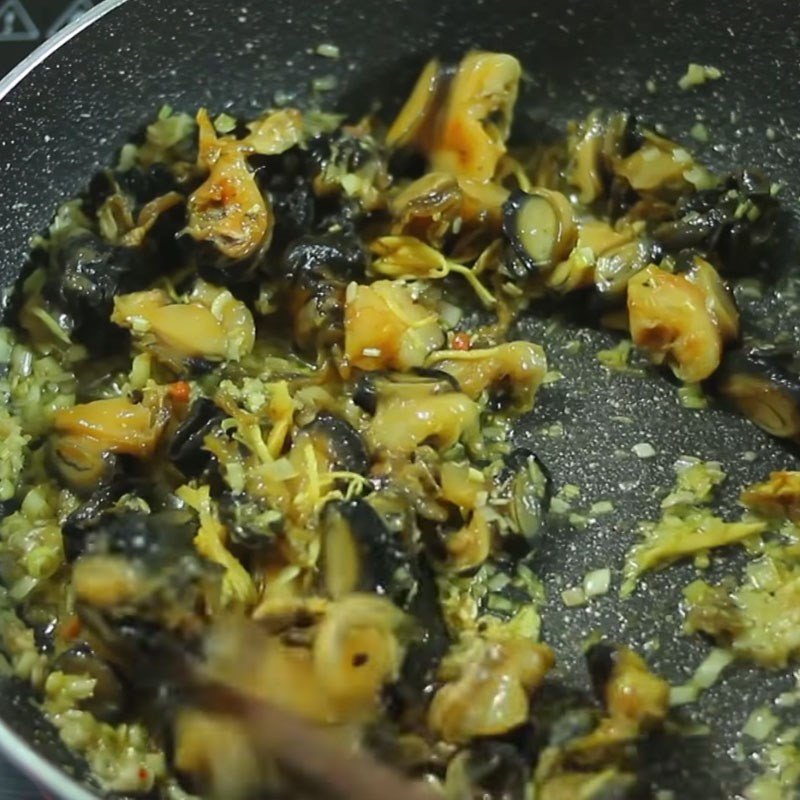 Hoàn thiện món ốc xào sả ớt với lá chanh và ớt tươi