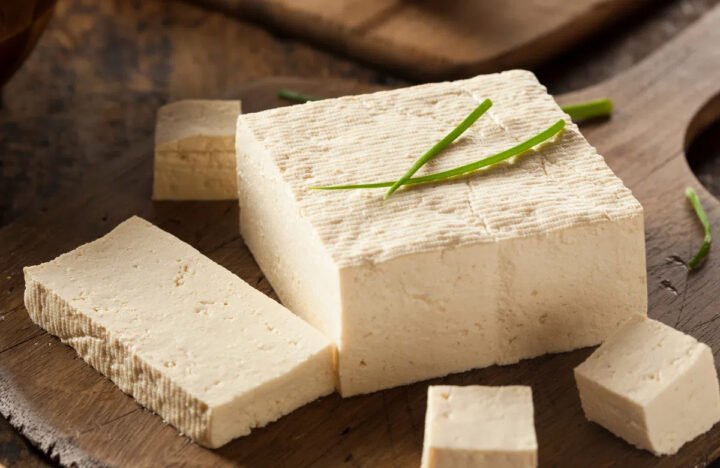 Miếng tàu hủ trắng mịn trên đĩa gỗ, đại diện cho thực phẩm ít calo.