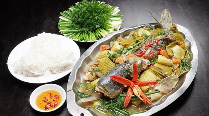 Món cá chép om dưa nóng hổi, thịt cá vàng óng, dưa cải chua giòn, chuẩn vị ẩm thực Việt.