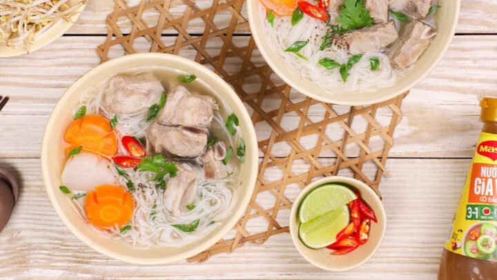 Một tô hủ tiếu bò kho nghi ngút khói với sợi hủ tiếu, thịt bò, cà rốt và rau thơm