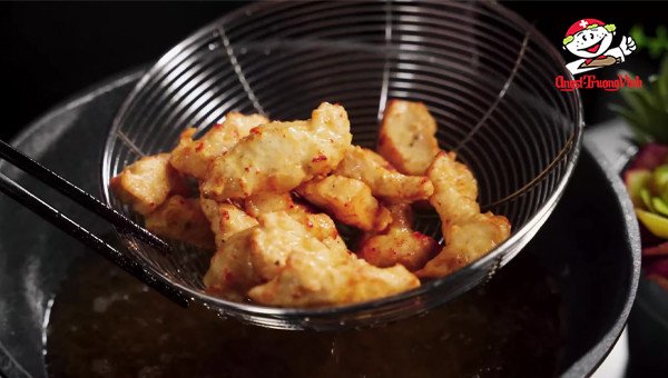 Những miếng ức gà vàng giòn đang được chiên ngập dầu, chuẩn bị cho món ức gà chiên nước mắm thơm ngon