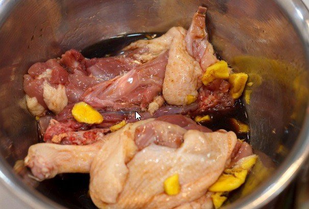 Ướp gia vị đều khắp mình vịt nguyên con để chuẩn bị cho món vịt tiềm nước dừa