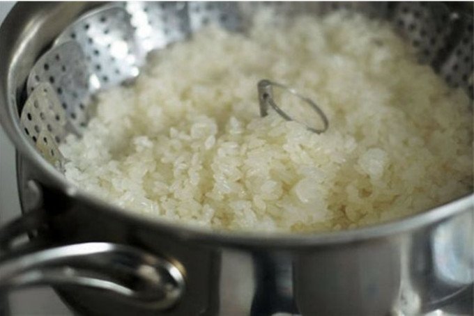 Xôi đang được hấp lần hai trong xửng, giúp xôi đạt độ mềm dẻo và giữ ấm lâu hơn